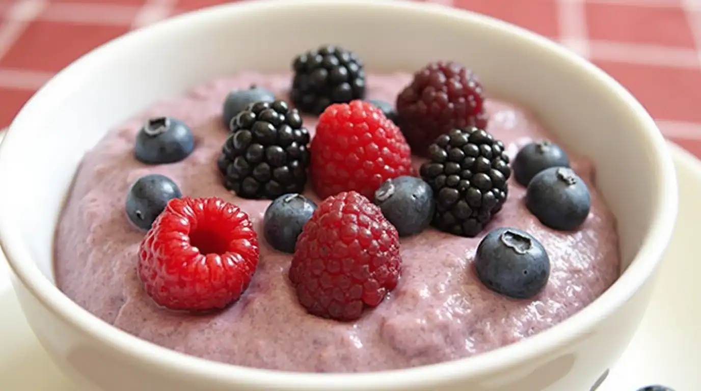 Fresh mixed berries topped on creamy yogurt bowl, healthy fruit breakfast, blackberries, blueberries, raspberries for wellness nutrition, Recipestang recipe ideas.