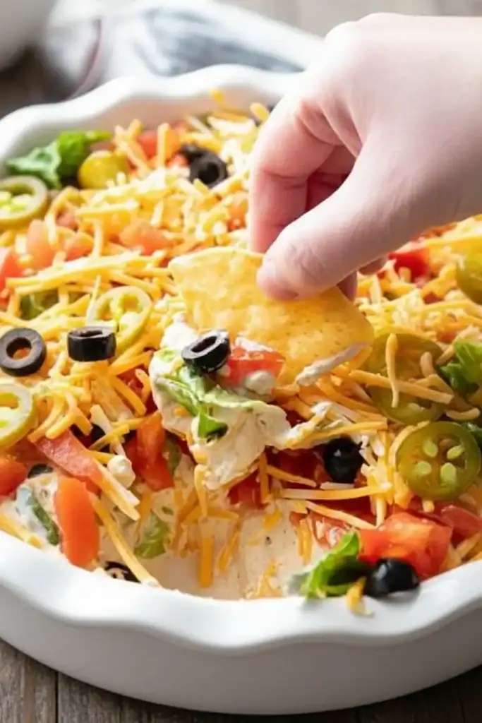 Delicious cheesy salad nachos with fresh vegetables and melted cheese, perfect for snacking or parties. Enjoy crispy chips topped with fresh ingredients for a satisfying treat.